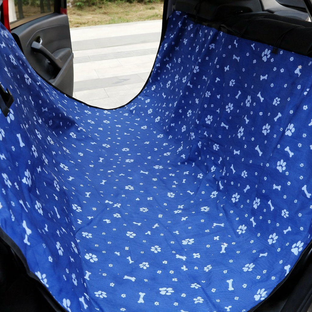 Blue and white paw print waterproof dog car seat cover, rear hammock style with safety belt for transporting pets.