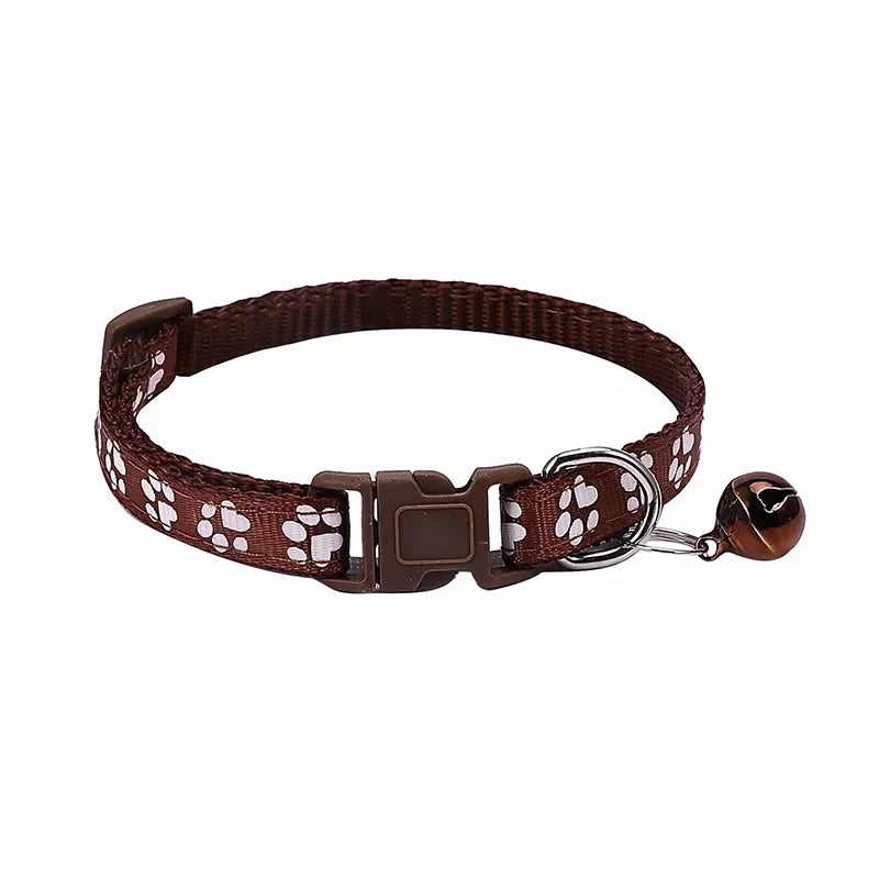 Brown adjustable nylon cat collar with bell from TrendyPet's Zone, shown with a pink collar on a cat, available in 19 colors.