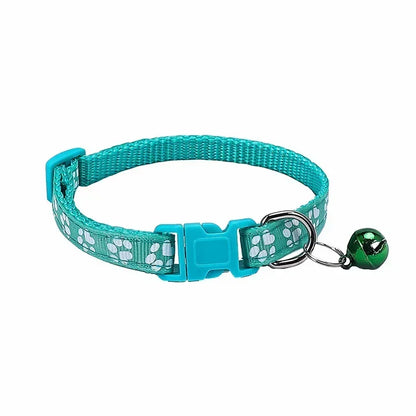 Cyan adjustable nylon cat collar with bell and paw print design, worn by a cat with a pink collar, in various colors.