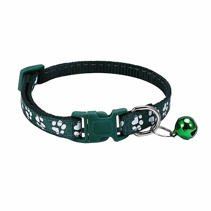 Dark green adjustable nylon cat collar with bell and paw print design, shown on a cat wearing a pink collar, with other color options visible.