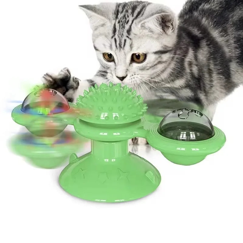 Green rotating windmill cat toy with LED lights on a turntable with suction cup base, designed for interactive feline play.