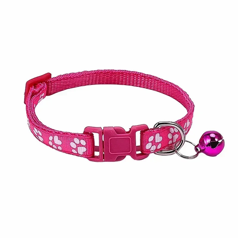 Pink adjustable nylon cat collar with bell and paw print design, worn by a cat; available in multiple colors by TrendyPet's Zone.