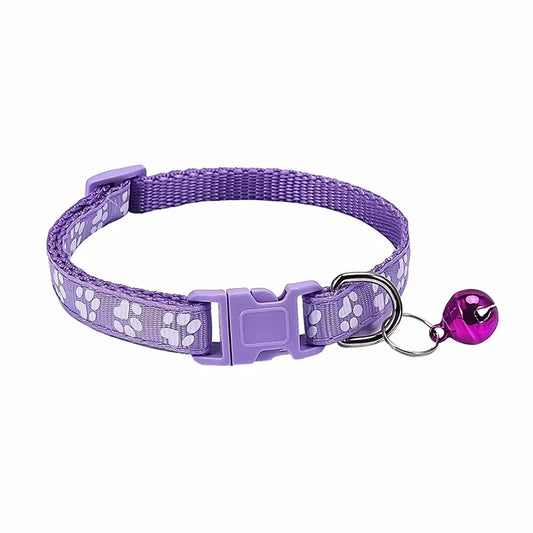 Purple adjustable nylon cat collar with soft paw print design and bell, suitable for cats and small dogs, in multiple colors.