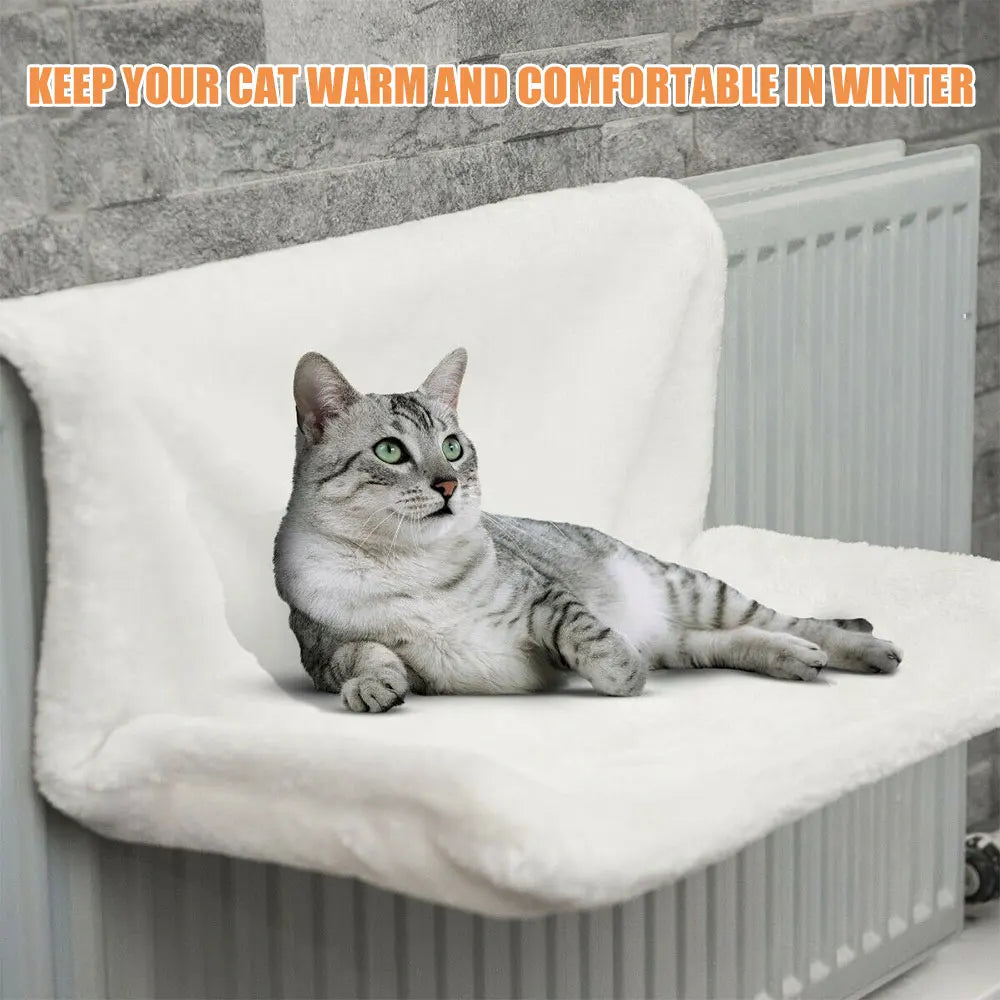 White collapsible cat hammock bed hanging on a radiator, cozy cradle for cats by TrendyPet's Zone.